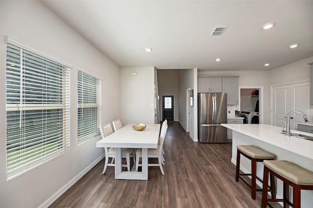 101 Goosewood Dr, Mckinney, TX 75071 - dining space with independent washer and dryer, plenty of natural light, baseboards, dark wood finished floors, and recessed lighting