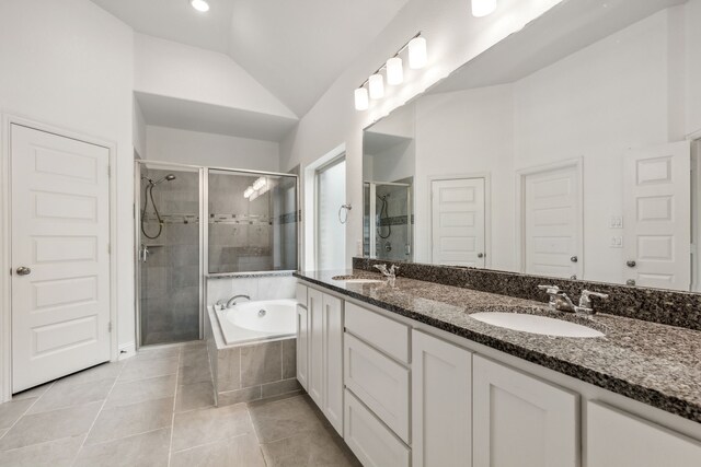 906 Overton Ave, Celina, TX 75009 - bathroom with a stall shower, lofted ceiling, a bath, double vanity, and tile patterned floors