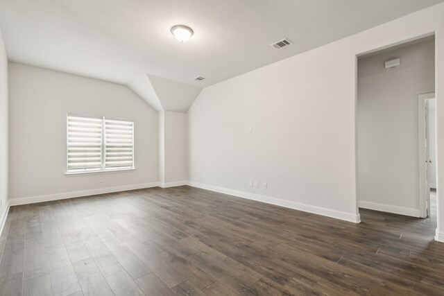 906 Overton Ave, Celina, TX 75009 - unfurnished room featuring dark wood-type flooring, baseboards, and vaulted ceiling