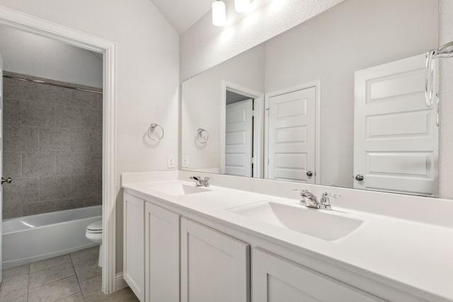 906 Overton Ave, Celina, TX 75009 - full bathroom featuring toilet, double vanity, tile patterned floors, bathtub / shower combination, and vaulted ceiling