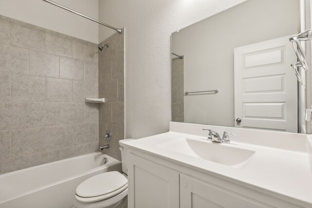 906 Overton Ave, Celina, TX 75009 - bathroom with toilet, vanity, bathing tub / shower combination, and a textured wall
