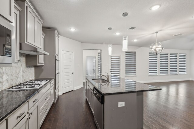 906 Overton Ave, Celina, TX 75009 - kitchen with a sink, under cabinet range hood, appliances with stainless steel finishes, decorative backsplash, and baseboards