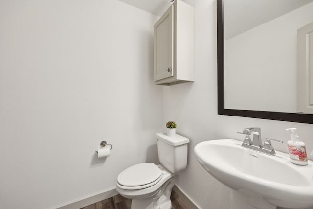 317 Mcconathy Way, Flower Mound, TX 75028 - half bath with a sink, wood finished floors, toilet, and baseboards