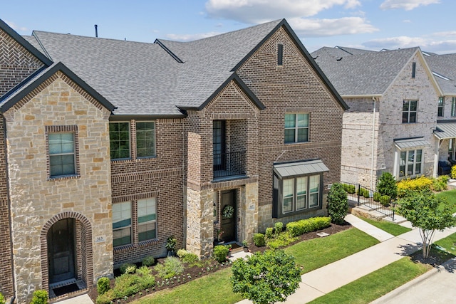 317 Mcconathy Way, Flower Mound, TX 75028 - view of front facade featuring stone siding, roof with shingles, and brick siding