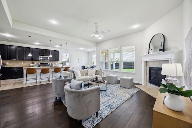1901 Brahorn Ln, Fort Worth, TX 76131 - living room featuring ceiling fan, hardwood / wood-style flooring, recessed lighting, a tiled fireplace, and baseboards