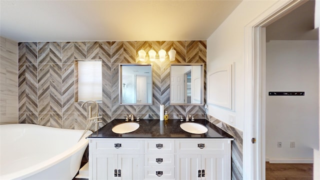 4917 Meadow Vista Pl, Garland, TX 75043 - bathroom featuring a freestanding bath, double vanity, and tasteful backsplash