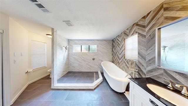 4917 Meadow Vista Pl, Garland, TX 75043 - full bathroom with vanity, a freestanding bath, a stall shower, toilet, and tile patterned floors