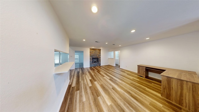 4917 Meadow Vista Pl, Garland, TX 75043 - unfurnished living room featuring a fireplace, recessed lighting, light wood-style flooring, and baseboards