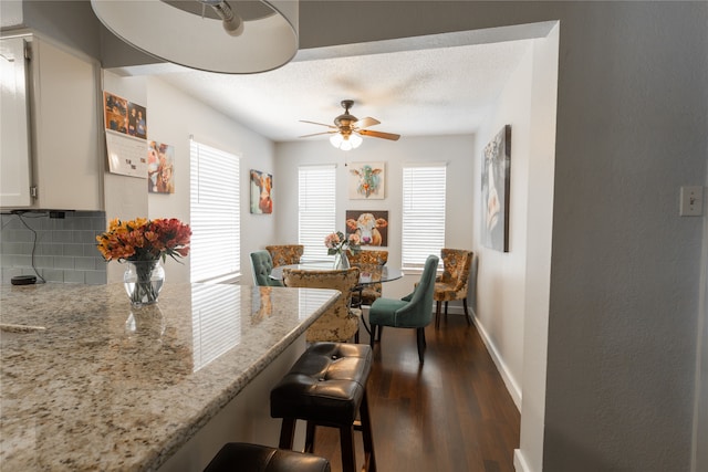 6304 Kary Lynn Dr S, Watauga, TX 76148 - dining space featuring dark wood-style floors, a ceiling fan, baseboards, and a textured ceiling