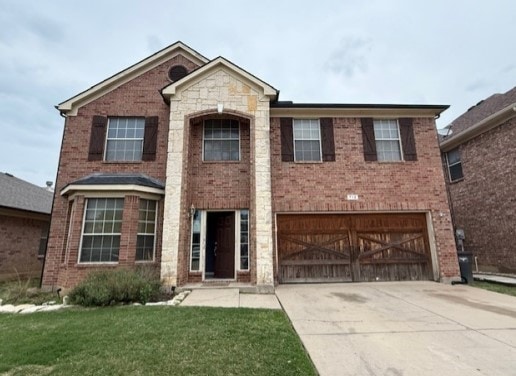 712 Mistymoor Ln, Fort Worth, TX 76052 - view of front of home featuring a garage, driveway, brick siding, and a front lawn