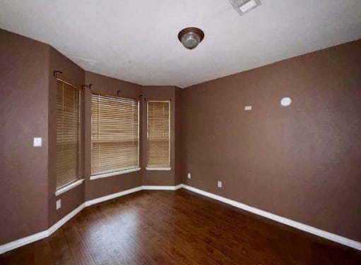 712 Mistymoor Ln, Fort Worth, TX 76052 - spare room featuring wood finished floors and baseboards