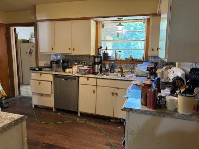 4132 Fm 546, Princeton, TX 75407 - kitchen with stainless steel dishwasher, light countertops, dark wood-type flooring, a sink, and decorative backsplash