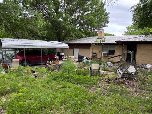 4132 Fm 546, Princeton, TX 75407 - back of property featuring a chimney, metal roof, brick siding, and cooling unit