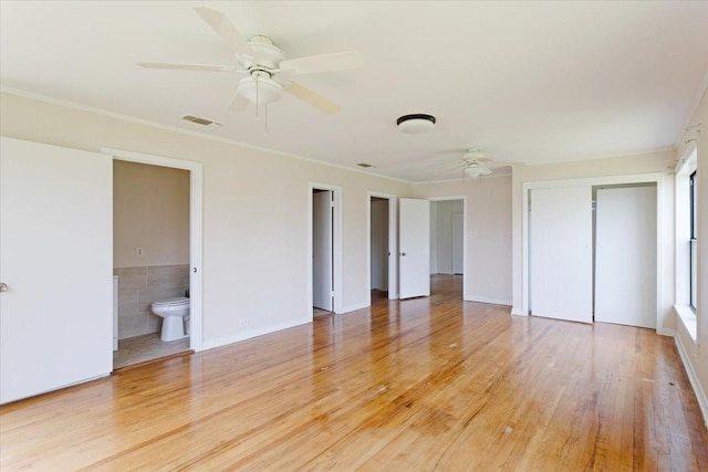 104 Mackinnon, Mount Pleasant, TX 75455 - unfurnished bedroom with light wood finished floors, ornamental molding, a closet, ensuite bathroom, and a ceiling fan