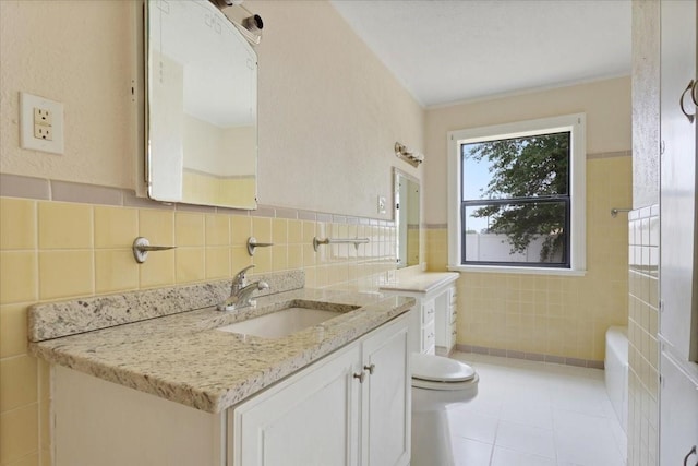 104 Mackinnon, Mount Pleasant, TX 75455 - bathroom featuring tile walls, vanity, toilet, and tile patterned flooring