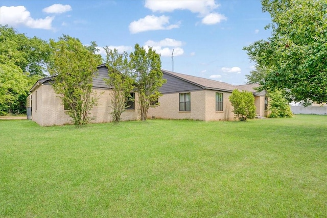 104 Mackinnon, Mount Pleasant, TX 75455 - rear view of property with a lawn and brick siding