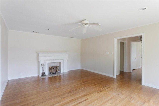 104 Mackinnon, Mount Pleasant, TX 75455 - unfurnished living room featuring ceiling fan, light wood finished floors, baseboards, and ornamental molding
