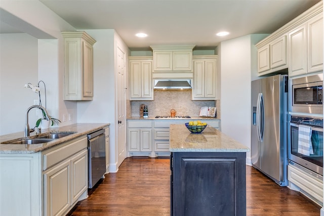 131 Lavaca Dr, Irving, TX 75039 - kitchen featuring appliances with stainless steel finishes, a sink, a center island, exhaust hood, and dark wood finished floors