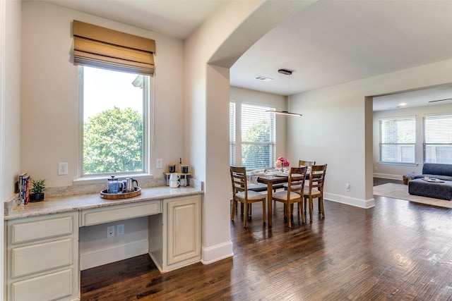 131 Lavaca Dr, Irving, TX 75039 - dining area with plenty of natural light, dark wood-style floors, and baseboards