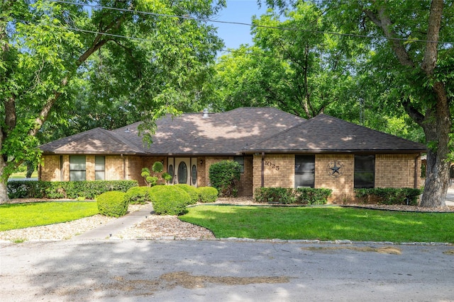 1025 S Lamar St, De Leon, TX 76444 - view of front facade with brick siding, a front yard, and a shingled roof
