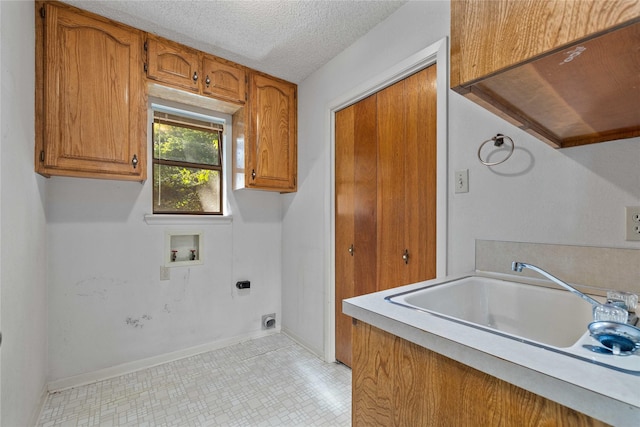 1025 S Lamar St, De Leon, TX 76444 - washroom with hookup for a washing machine, electric dryer hookup, cabinet space, a textured ceiling, and baseboards
