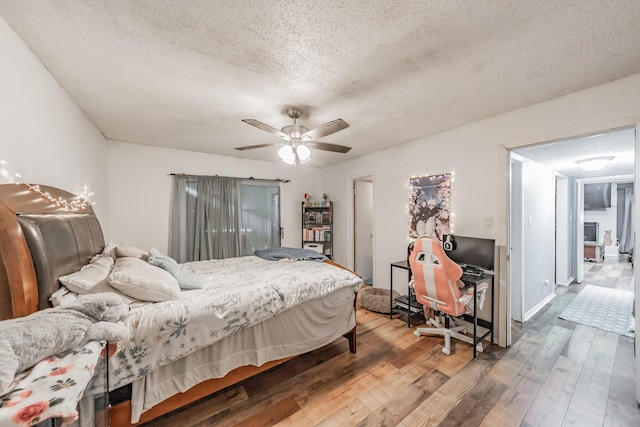 2216 Brigadoon Ct, Arlington, TX 76013 - bedroom with a textured ceiling, hardwood / wood-style flooring, and ceiling fan