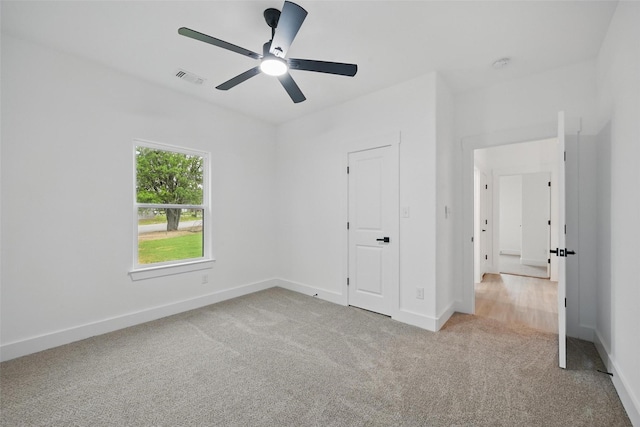 2738 W Washington St, Denison, TX 75020 - unfurnished bedroom with carpet floors, baseboards, and ceiling fan