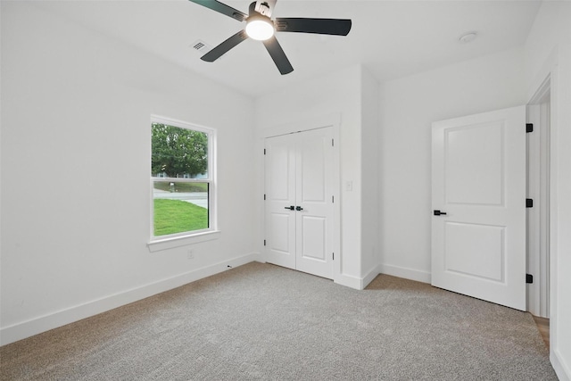 2738 W Washington St, Denison, TX 75020 - unfurnished bedroom with carpet flooring, baseboards, a ceiling fan, and a closet