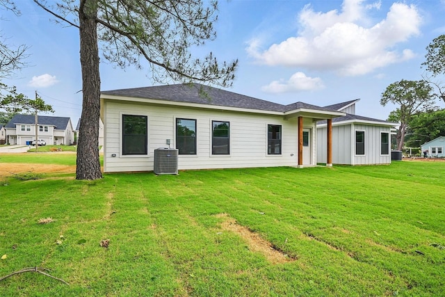 2738 W Washington St, Denison, TX 75020 - back of property featuring a lawn, central AC unit, and board and batten siding