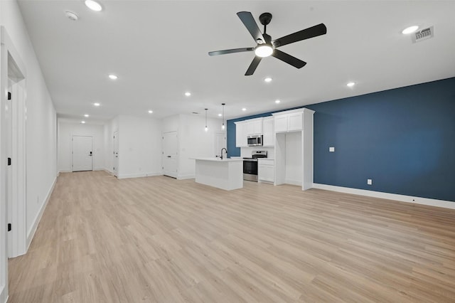 2738 W Washington St, Denison, TX 75020 - unfurnished living room featuring a sink, light wood-style flooring, ceiling fan, recessed lighting, and baseboards