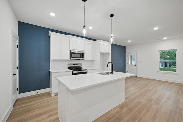 2738 W Washington St, Denison, TX 75020 - kitchen featuring appliances with stainless steel finishes, white cabinetry, a sink, baseboards, and recessed lighting