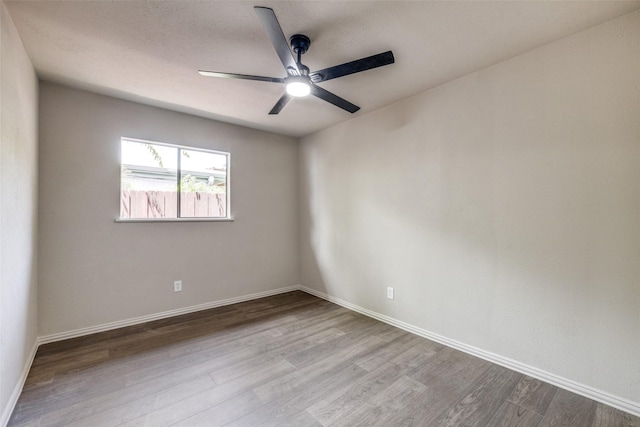 1336 Whittenburg Dr, Fort Worth, TX 76134 - spare room featuring wood finished floors, a ceiling fan, and baseboards