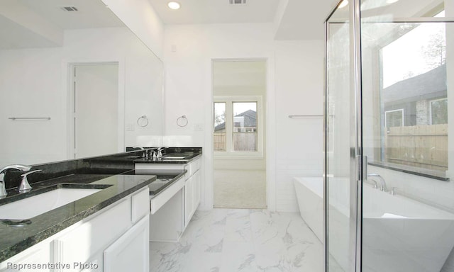 8409 Peach St, Justin, TX 76247 - bathroom featuring vanity, a freestanding tub, marble finish floors, a stall shower, and recessed lighting