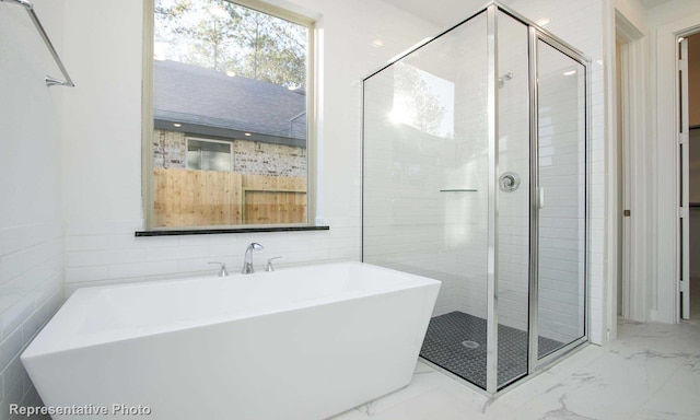 8409 Peach St, Justin, TX 76247 - bathroom featuring marble look tiles, a soaking tub, a shower stall, and tile walls