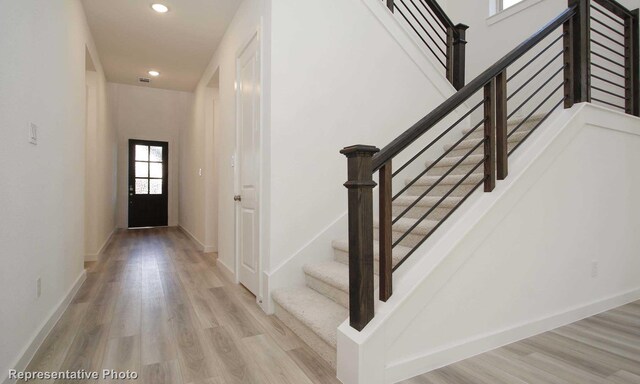 8409 Peach St, Justin, TX 76247 - entryway with recessed lighting, wood finished floors, stairs, and baseboards