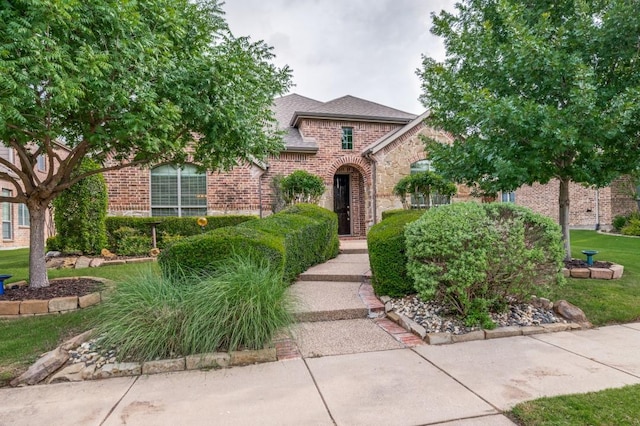 5946 Wallis Dr, Frisco, TX 75033 - view of front of home featuring brick siding, stone siding, and a shingled roof