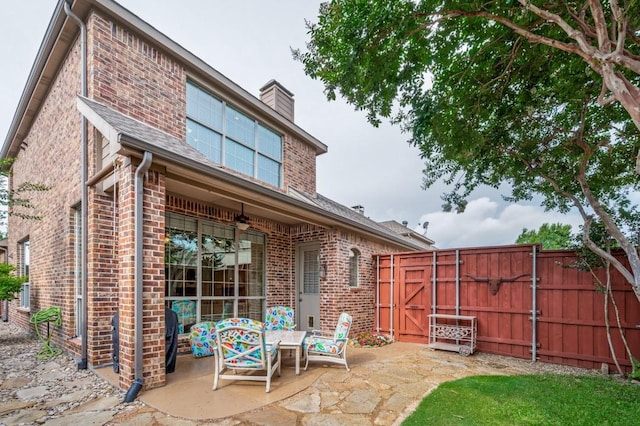 5946 Wallis Dr, Frisco, TX 75033 - rear view of property with a gate, brick siding, a patio area, and a chimney