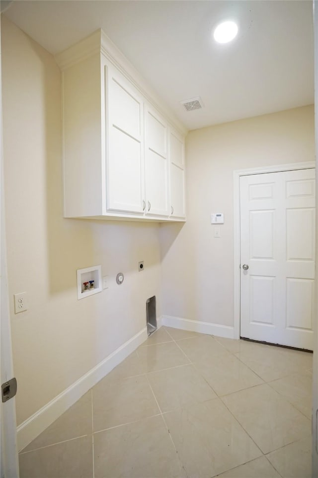720 Madeline Ct, Azle, TX 76020 - laundry room with cabinet space, hookup for an electric dryer, washer hookup, light tile patterned floors, and baseboards