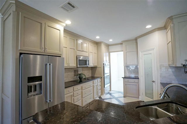 720 Madeline Ct, Azle, TX 76020 - kitchen with appliances with stainless steel finishes, a sink, recessed lighting, tasteful backsplash, and dark stone countertops