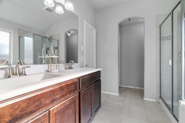 4130 Gaillardia Way, Forney, TX 75126 - bathroom with a shower stall, double vanity, tile patterned floors, vaulted ceiling, and baseboards