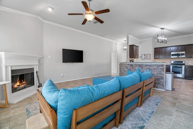 4130 Gaillardia Way, Forney, TX 75126 - living area featuring ornamental molding, a glass covered fireplace, a ceiling fan, and a chandelier