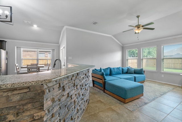 4130 Gaillardia Way, Forney, TX 75126 - living area with lofted ceiling, healthy amount of natural light, crown molding, a ceiling fan, and baseboards