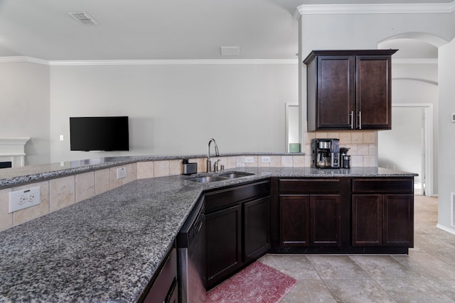 4130 Gaillardia Way, Forney, TX 75126 - kitchen with a sink, stone counters, crown molding, tasteful backsplash, and dark brown cabinetry