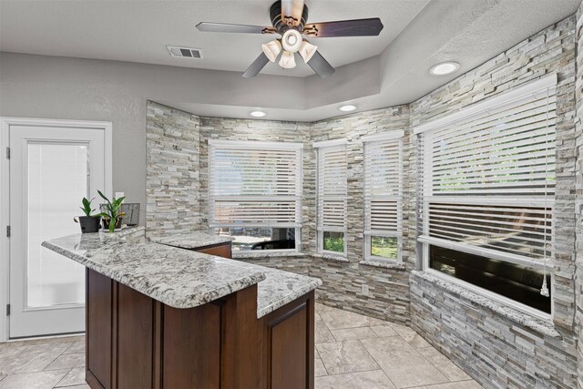 5655 Redgum Dr, Fort Worth, TX 76244 - kitchen featuring ceiling fan, a peninsula, and dark brown cabinetry