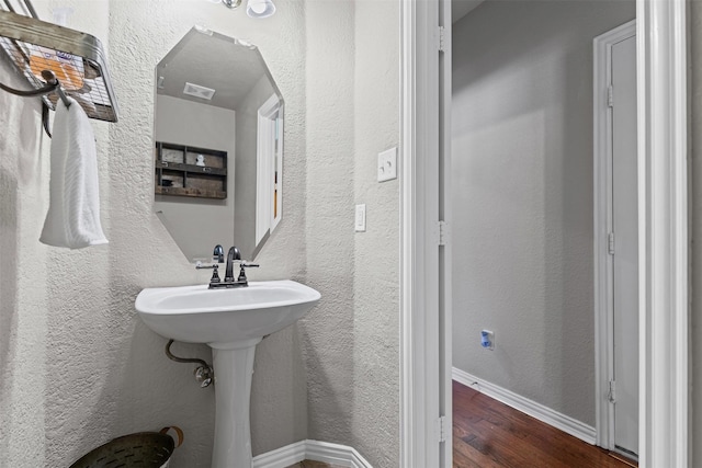 5655 Redgum Dr, Fort Worth, TX 76244 - bathroom featuring wood finished floors, a textured wall, and baseboards