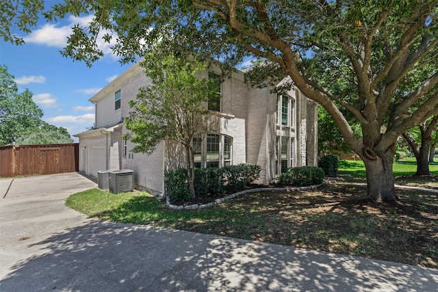 5655 Redgum Dr, Fort Worth, TX 76244 - view of property exterior with brick siding, driveway, central AC, and an attached garage