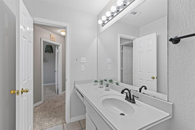 5655 Redgum Dr, Fort Worth, TX 76244 - bathroom featuring vanity, tile patterned floors, and a textured wall