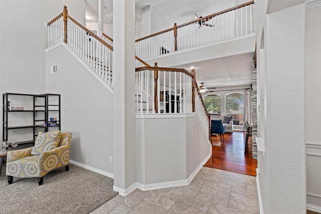 5655 Redgum Dr, Fort Worth, TX 76244 - stairway with ceiling fan, stone tile flooring, baseboards, and a high ceiling