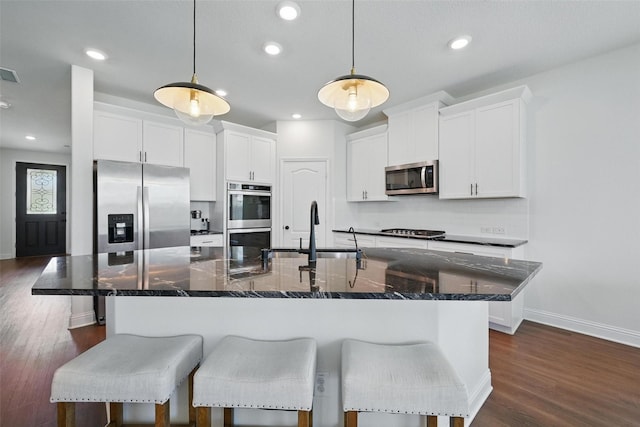 3501 Alamosa River Dr, Prosper, TX 75078 - kitchen with appliances with stainless steel finishes, a sink, baseboards, white cabinets, and dark wood-style floors