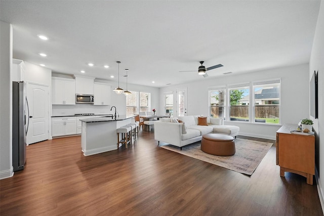 3501 Alamosa River Dr, Prosper, TX 75078 - living area with recessed lighting, healthy amount of natural light, dark wood finished floors, ceiling fan, and baseboards